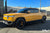 Compass Yellow Rivian R1T with Triple Square Running Boards