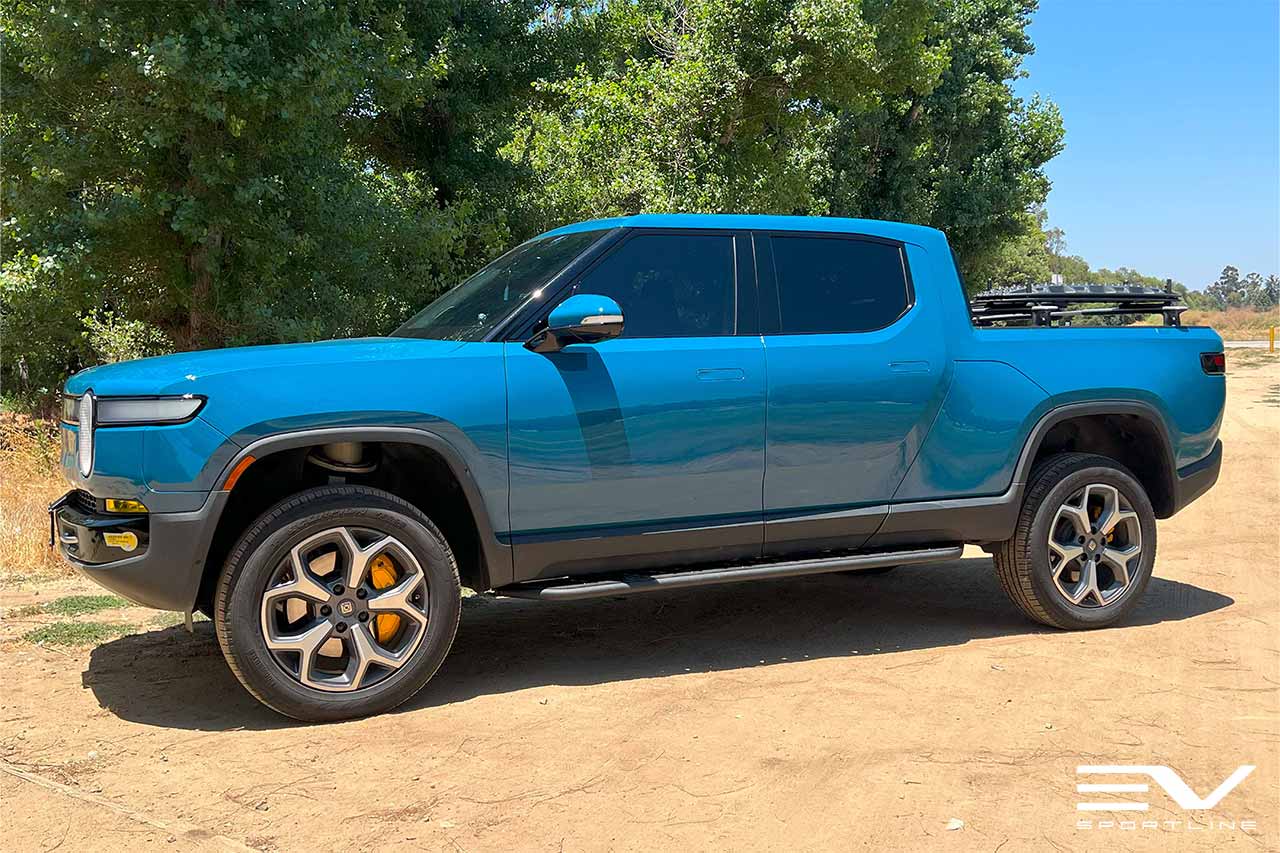 Rivian Blue Rivian R1T with Triple Slot Thread Rock Sliders